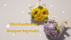 two small crocheted flowers are sitting on a white surface with the words mini sunflower bouquet keychain