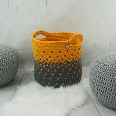 three crocheted baskets sitting next to each other on a white furnishing