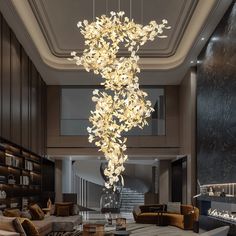 a large chandelier hanging from the ceiling in a living room filled with furniture