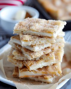 a stack of desserts sitting on top of a white plate next to a bowl