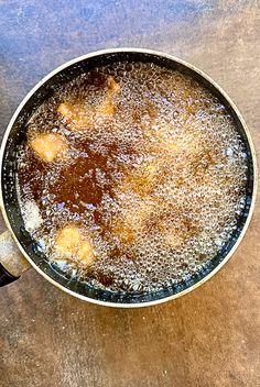 a frying pan filled with food on top of a wooden table