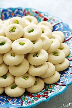 a blue and white plate filled with small cookies