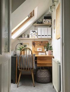 a room with a chair, desk and shelves in it