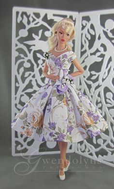 a barbie doll wearing a dress with flowers on it