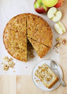 an apple pie with one slice cut out on a plate next to the whole pie