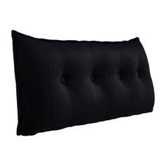 a black pillow with buttons on the front and back side, sitting against a white background