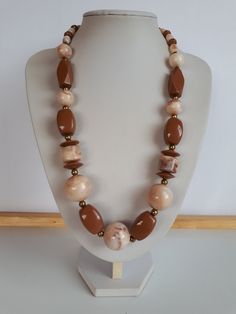 very beautiful piece! Vintage Retro chunky milk chocolate brown and swirl milk chocolate brown and biege lucite plastic beaded necklace with gold metal accent and different shapes and sizes of beads with lustrous surface with no seems and claps.  Circa 1975-1980. length: 24.5 inches; biggest ball beads: 7/8 inches diameter. good condition  To make this a smooth and pleasant transaction experience for everyone, all buyers need to read and understand the description, the terms of sale , the paymen Plastic Necklace, Chunky Bead Necklaces, Chunky Beads, Vintage Lucite, Bead Jewellery, Necklace Vintage, Plastic Beads, Milk Chocolate, Metallic Accents