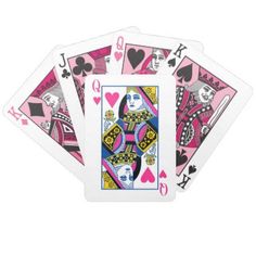 four playing cards with pink and blue designs on the front, two are black and one is