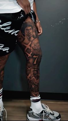 a man with tattoos on his legs and leg