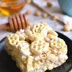 a black plate topped with cereal krispy treats