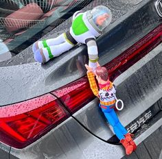 a toy man hanging from the back of a car