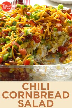 a casserole dish filled with cornbread and vegetables, topped with shredded cheese