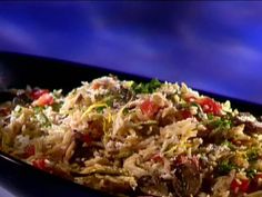 a bowl filled with rice and vegetables on top of a table