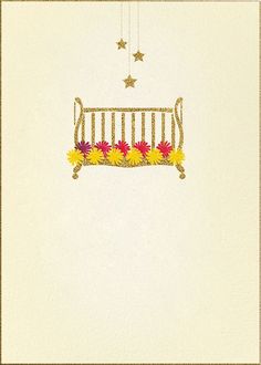 a baby crib with daisies and stars hanging from it's side on a white wall