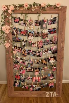 a wooden frame filled with pictures and flowers