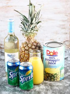 pineapple, pineapple juice, and other drinks are on the table