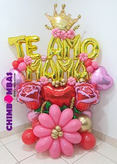 a bouquet of flowers and balloons in the shape of letters