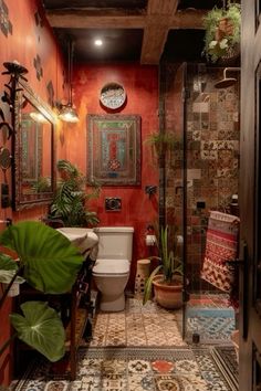 a bathroom with red walls, tiled floors and potted plants on the counter top