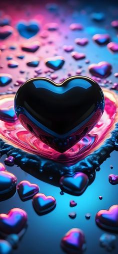 a heart shaped object sitting on top of a blue and pink liquid filled tablecloth