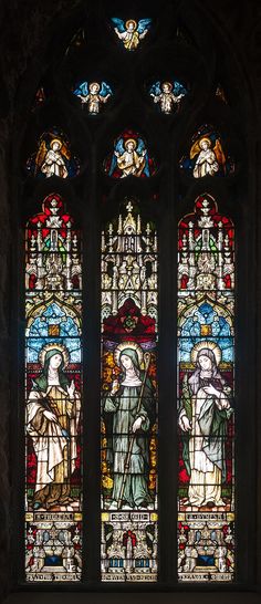 a stained glass window in the middle of a church with angels and saints on it