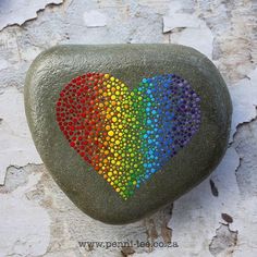 a colorful heart painted on a rock