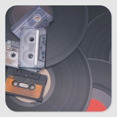 an old fashioned cassette player sitting on top of a record