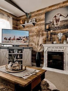 the living room is decorated in rustic style with wood paneling and cow heads on the wall