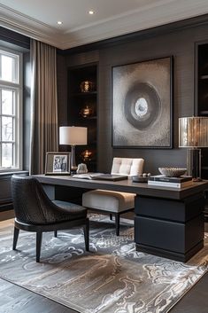 an elegant home office with dark wood paneling and black furniture, along with a large painting on the wall