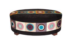 a black ottoman with colorful circles on it