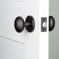 an open door with black handles and knobs