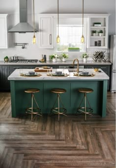 a kitchen with green cabinets and white counter tops