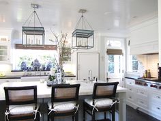 a kitchen with four chairs and a center island in front of the stove top oven