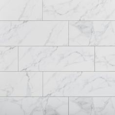 a white marble tile wall that looks like it has been made from the same material