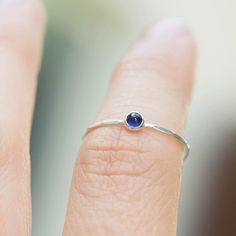 Tiny skinny stackable ring with beautiful deep blue Sapphire stone. It is made with a skinny but sturdy band, which allows you to create mind-blowing stacking sets! The ring is ideal for everyday wear and it will also look amazingly with a festive dress.The ring is 0,8-0,9 mm thick and looks very dainty on the finger. Choose the finish of the stone (smooth cabochon or rose cut) and material for the ring (sterling silver or 9k gold).If you want to change the ring band design or get a custom ring Minimalist Adjustable Sapphire Ring, Everyday Adjustable Stackable Birthstone Ring, Minimalist Sapphire Ring With Bezel Setting For Everyday, Blue Minimalist Sterling Silver Stackable Rings, Minimalist Blue Sterling Silver Stackable Rings, Blue Minimalist Stackable Sterling Silver Rings, Adjustable Solitaire Birthstone Ring For Everyday, Minimalist Sapphire Birthstone Ring With Round Band, Adjustable Bezel Setting Stackable Rings For Promise