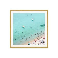 an aerial view of people on the beach and in the water, with small boats