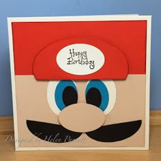 a birthday card with an image of mario's hat and mustache on the front