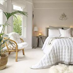 a bedroom with white walls and carpeted flooring