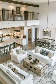 a living room filled with furniture next to a kitchen