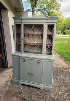 an old china cabinet is painted gray