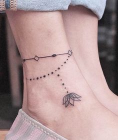 a woman's foot with a small tattoo on the side of her ankle and an arrow