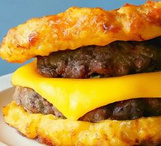 a cheeseburger on a plate with bacon and cheddar