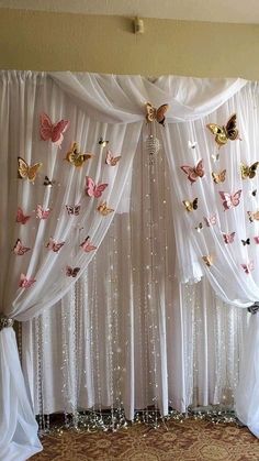 the curtains are decorated with butterflies and sequins for an elegant touch to this room