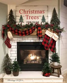 a fireplace decorated with christmas trees and stockings