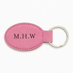 a pink leather keychain with the word h w on it's side