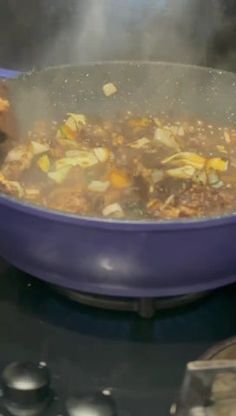 a pot filled with food sitting on top of a stove next to a frying pan