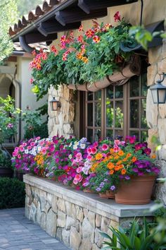 colorful flowers are growing in the window boxes