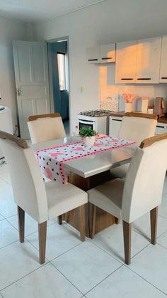 a kitchen table with four chairs around it