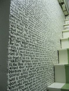 there is a wall with words written on it and stairs leading up to the top