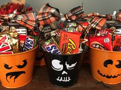 two buckets filled with candy and candies decorated as jack - o'- lanterns