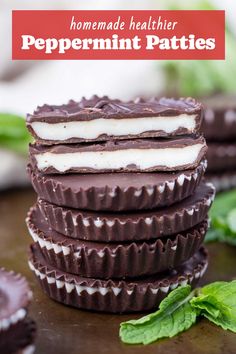 chocolate covered peppermint patties stacked on top of each other with mint leaves in the background